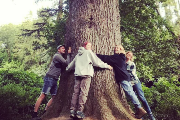 Foraging Folklore Woodland Walk group hugging tree
