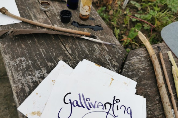 "Gallivanting" written with feather and branch