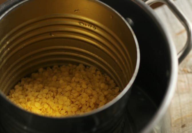 Melting beeswax using a tin can and saucepan